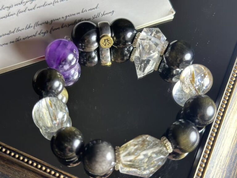 Black and gold crystal bracelet in motion, showing metallic luster and deep black hues in natural light