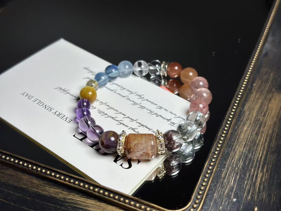 Close-up of the bracelet's core crystals, featuring Gold Rutilated Quartz, Green Phantom Quartz, Amethyst, and others.