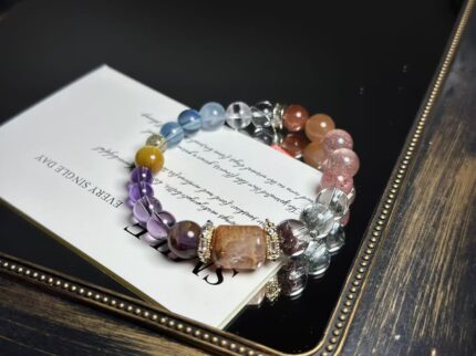 Close-up of the bracelet's core crystals, featuring Gold Rutilated Quartz, Green Phantom Quartz, Amethyst, and others.