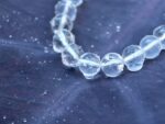 Close-up of clear quartz beads, revealing inner clarity and enhancing energy healing.