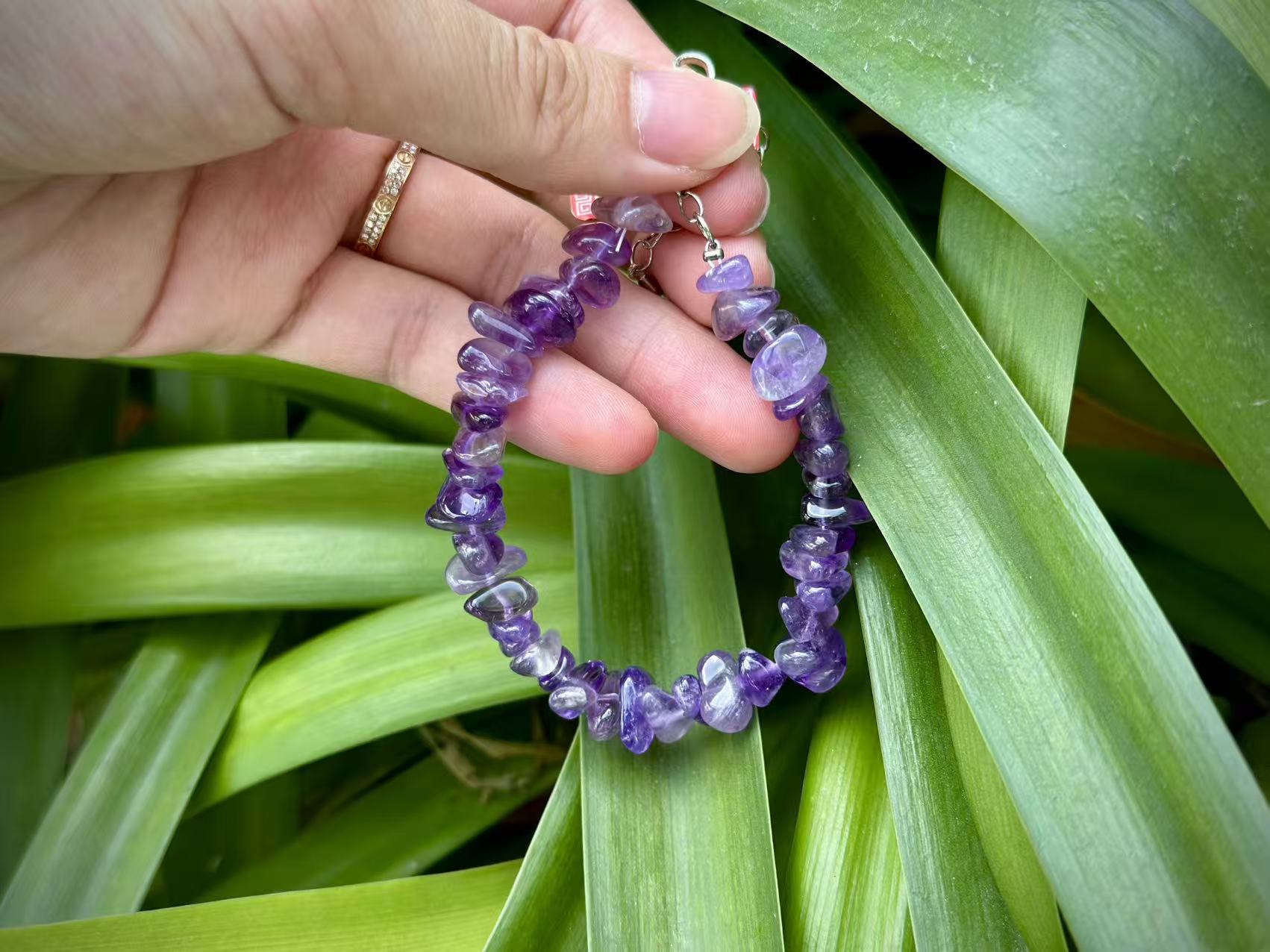 Five Elements Wisdom Amethyst - Balancing Water & Fire to Illuminate the Mind Amethyst bracelet arranged with deep blue silk and a candle, symbolizing the balance of Water and Fire.