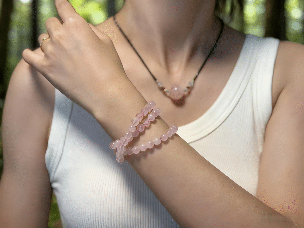 Close-up of Rose Quartz pendant, showing delicate texture and soft glow, a heart chakra amplifier.