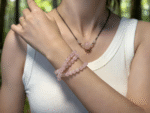 Close-up of Rose Quartz pendant, showing delicate texture and soft glow, a heart chakra amplifier.