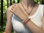 Model wearing Strawberry Quartz bracelet on wrist, exuding elegance and confidence.