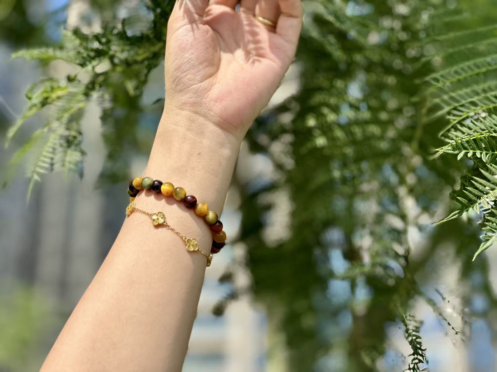 Model wearing the Multi-color Tiger's Eye bracelet on wrist, showcasing confident strength and unique style.