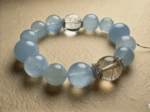 Aquamarine, Rutilated Quartz, Clear Quartz bracelet, blue, white, and gold colors interwoven, forming a communication-wealth-purification energy cycle.