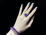 Amethyst ring in purple gift box with energy card, ready to give wisdom blessings.