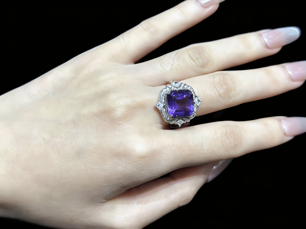 Amethyst ring in reading/study setting, with books and notebook.